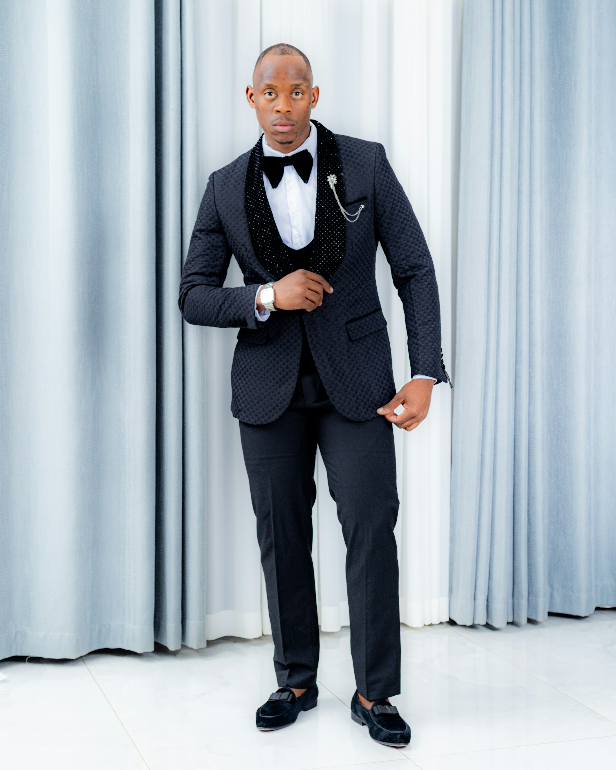 A guest in formal black-tie attire, ready for an executive celebration.